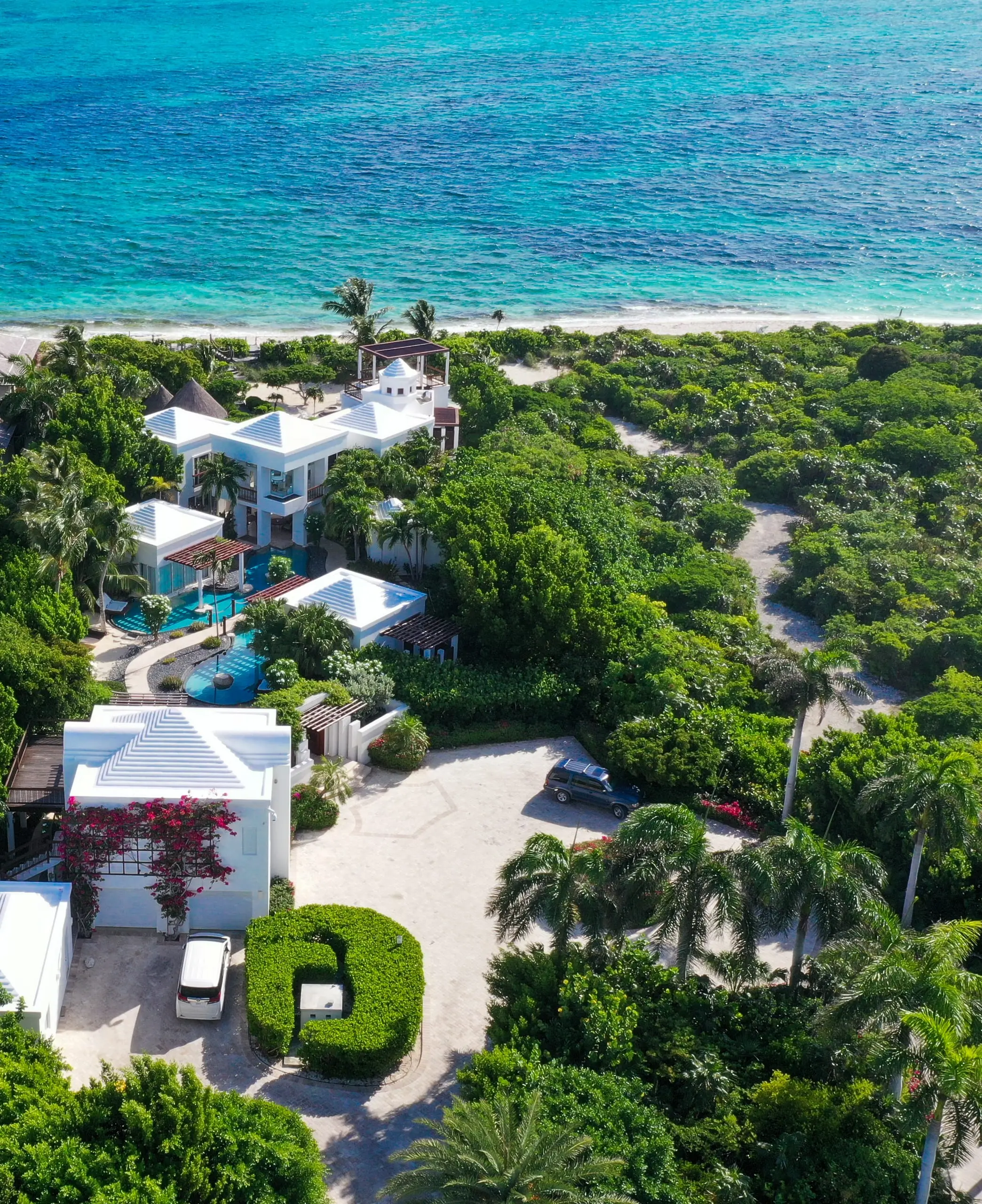 The entrance court, the gardens and the villa, with Grace Bay beyond